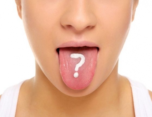 Отпечатки зубов на языке по бокам: причины и лечение